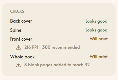 The Mementa cover checks panel reporting the back cover and spine as Looks good, the front cover as Will print with a warning that it is 216 PPI where 300 is recommended, and the whole book as Will print with 8 blank pages added to reach 32
